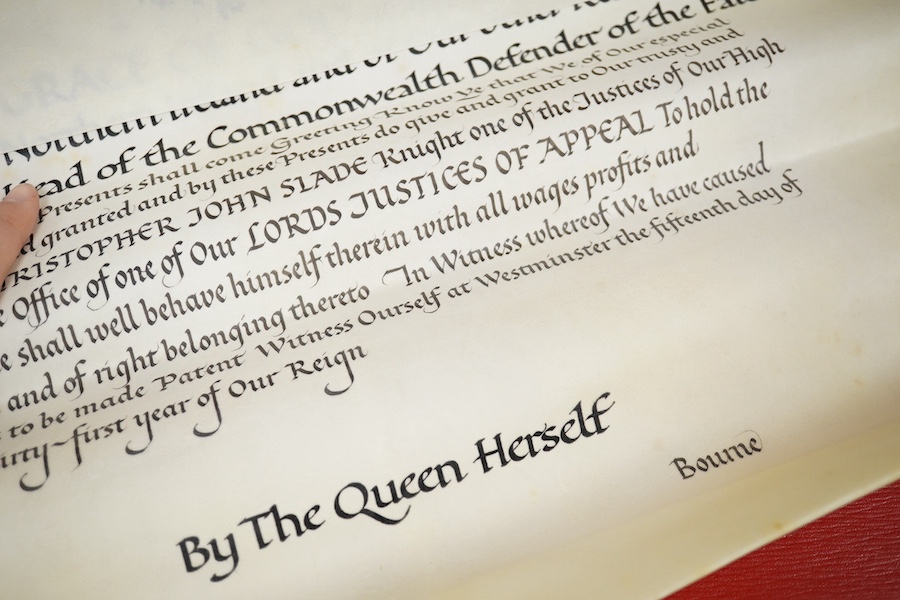 The Hon. Lord Justice Slade, ‘A Writ of Attendance at Parliament’, two vellum documents with ERII red seals in a red fitted case with a gold Royal Coat of Arms stamp, case 59cm wide x 23cm deep. Condition - some foxing